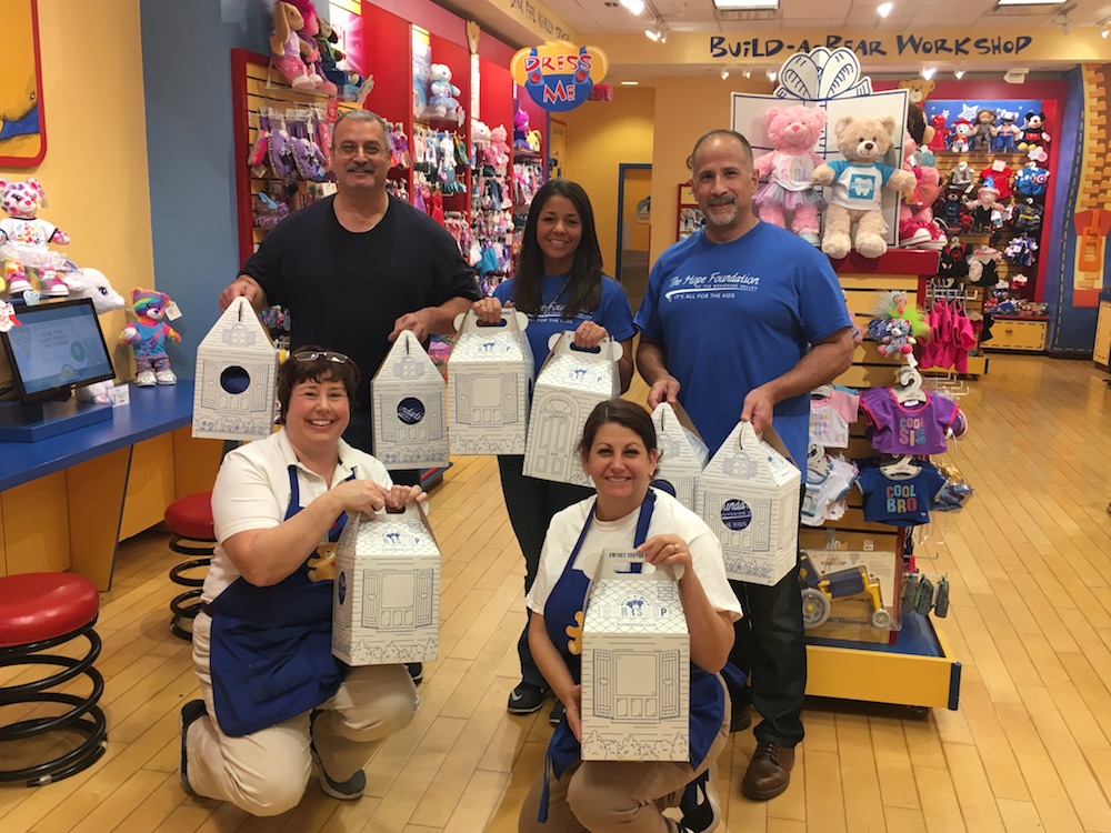 Hope Foundation Members Posing with Build a Bear Employees With Their Bears