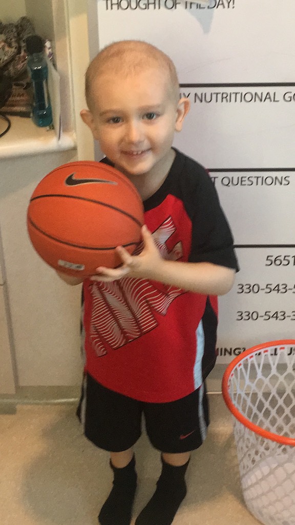 Child Showing Off Their New Basketball