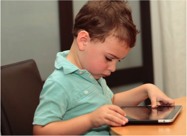 A Child Intently Using An IPad